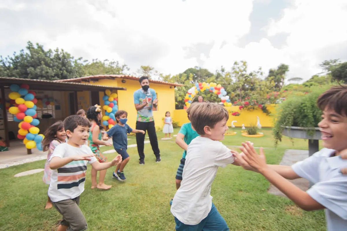 Kids running and playing at a backyard birthday party