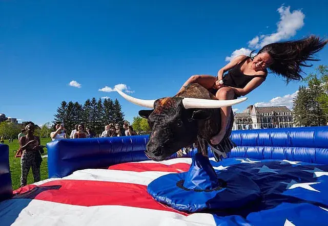 Rider on The Beast mechanical bull at an outdoor event