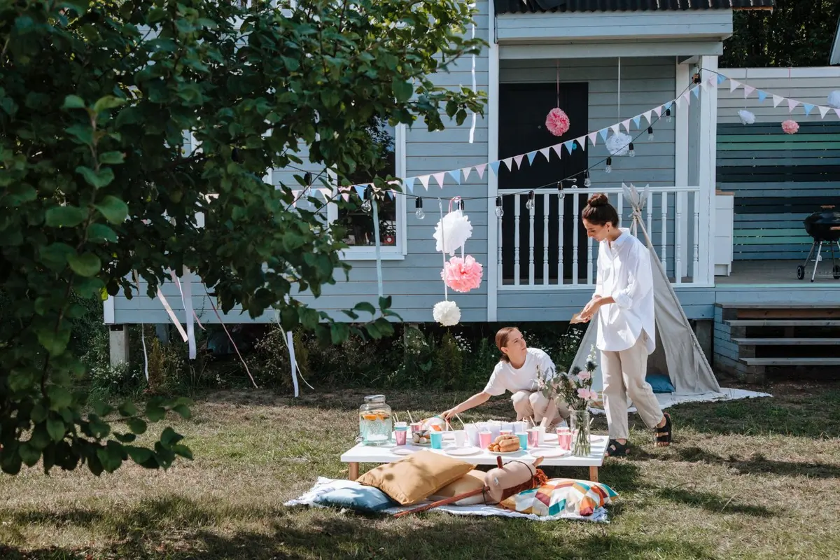 Adults setting up a backyard party before guests arrive
